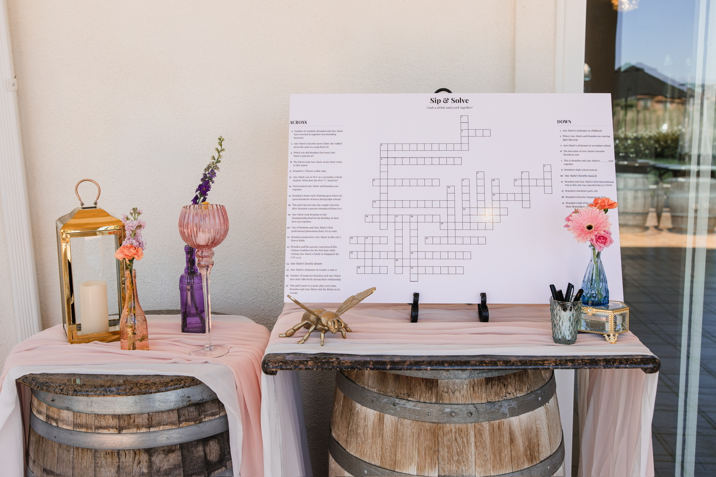 The finished Sip and Solve wedding crossword displayed on a laminated foam board at our reception